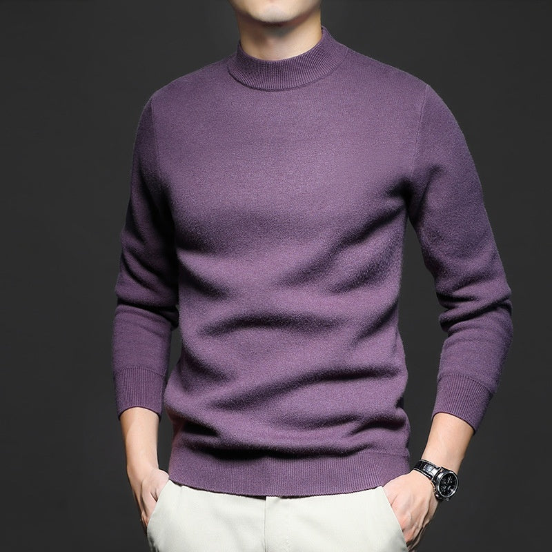 Man wearing a solid burgundy ribbed knit crewneck sweater with long sleeves. 