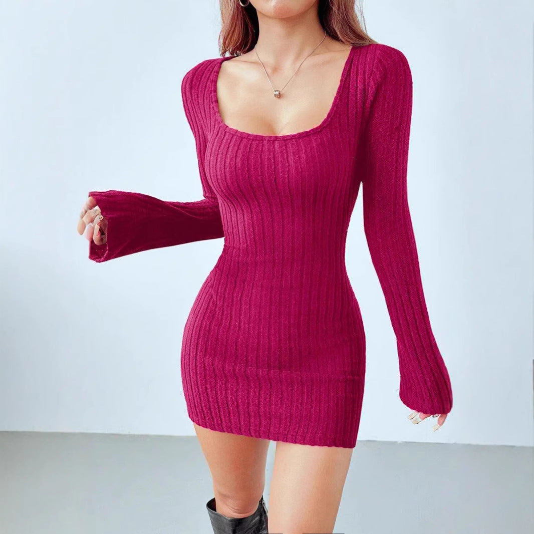 Woman wearing a black ribbed knit long sleeve mini dress with square neckline and bodycon fit, styled with 
gold accessories and knee-length faux leather boots.