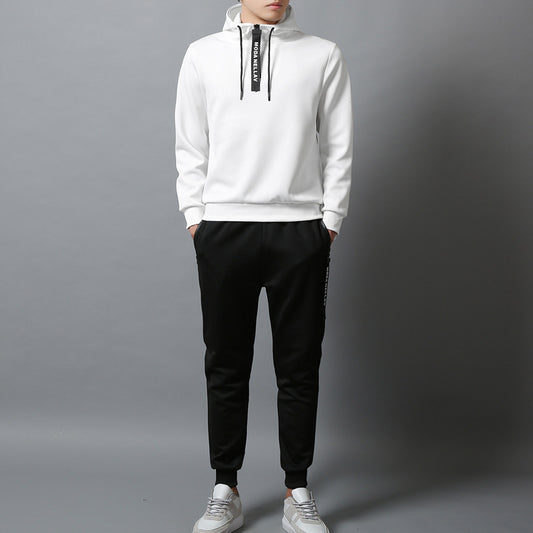 Men wearing a white minimalist athletic hoodie with drawstring hood paired with black jogger pants.