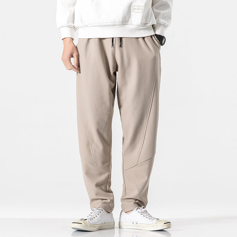 Beige jogger pants styled with white sweatshirt and sneakers, Threadspired fashion.