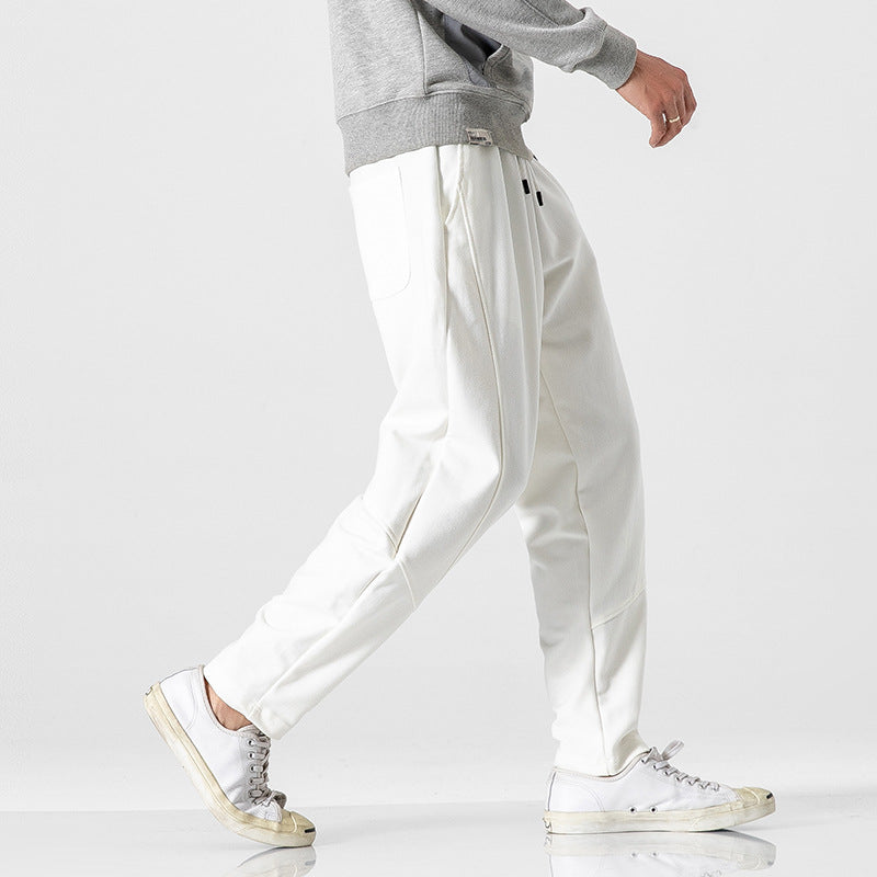 Threadspired white jogger pants styled with grey sweatshirt and white sneakers