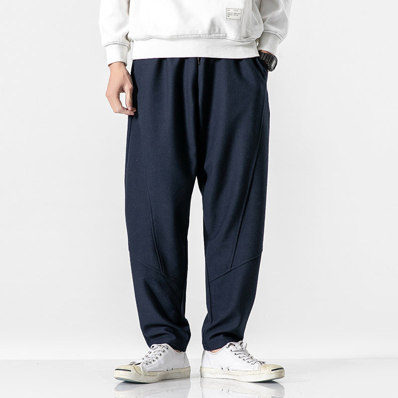 Man wearing navy blue relaxed fit pants and white sweatshirt, Threadspired fashion