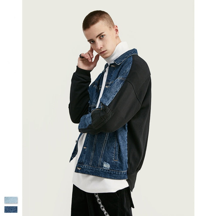 Men’s oversized blue distressed denim jacket with black contrast sleeve panels. 