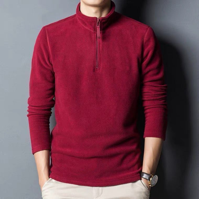 Man wearing a burgundy quarter zip long sleeve pullover with zipper neckline.