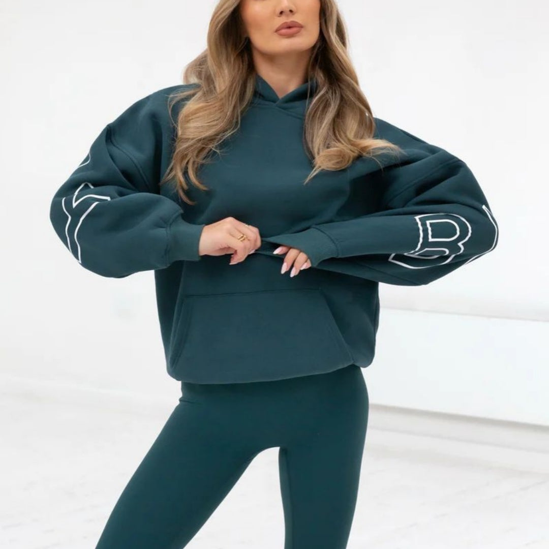 Back view of black oversized hoodie with large “BLAKELY” letter graphic print, smaller font “original life”, 
front view - oversized hoodie with pouch pocket.