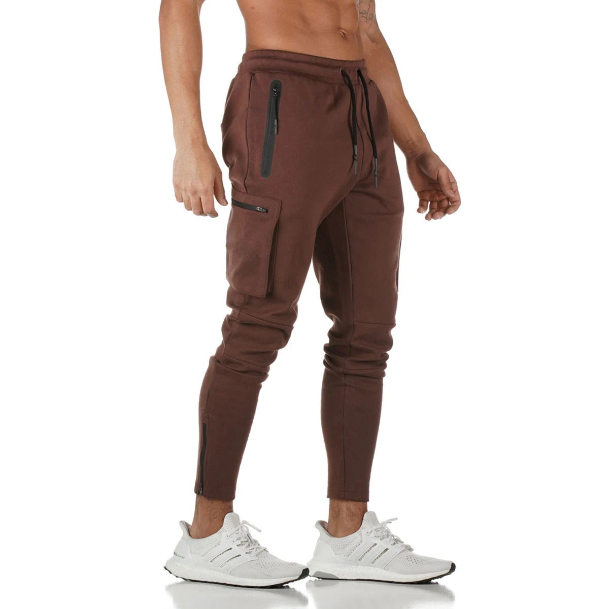 Black men’s slim fit cargo jogger pants with zip pocket detail, utility side pockets, and drawstring waistband 
on white background. 
