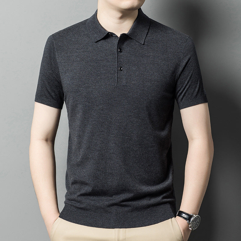 Man wearing a navy short sleeve knit polo shirt with button collar. 