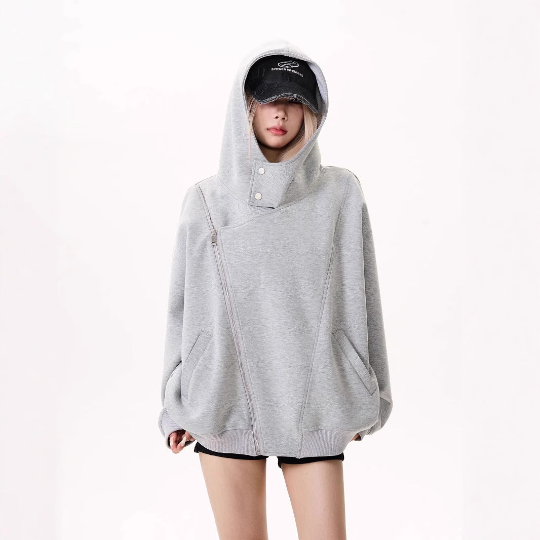 Woman wearing an oversized black asymmetrical zip hoodie jacket with hood and side pockets, styled with 
dark grey distressed baseball cap.