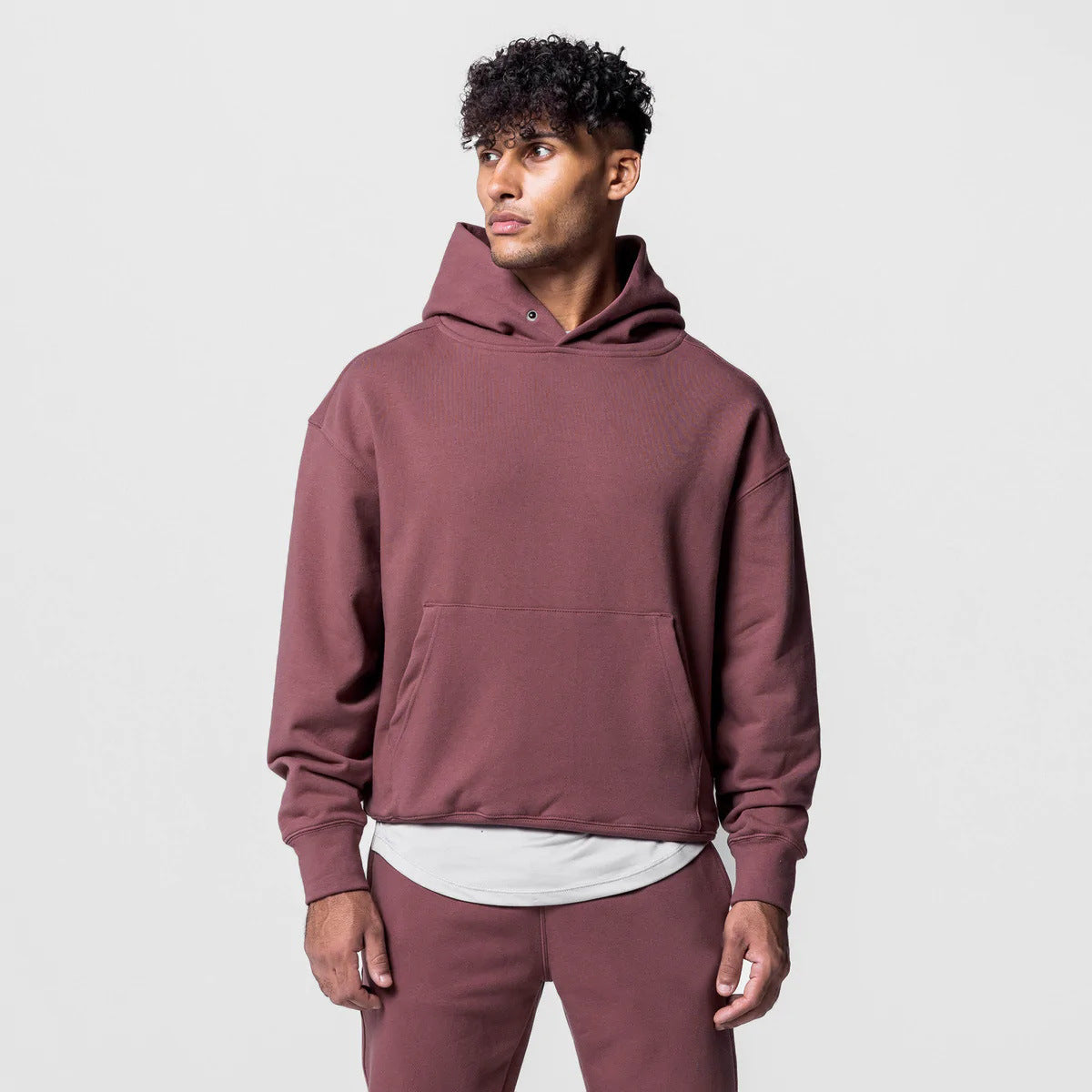 Oversized orange hoodie with minimalist design, dropped shoulders, kangaroo pocket, and relaxed 
heavyweight streetwear fit. 
