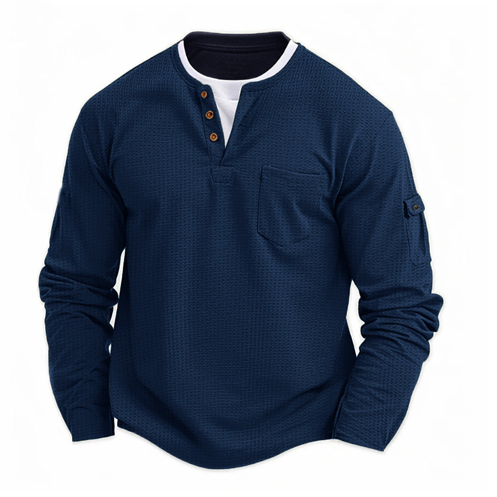 Navy blue men’s waffle knit long sleeve Henley shirt with chest pocket and button collar. 