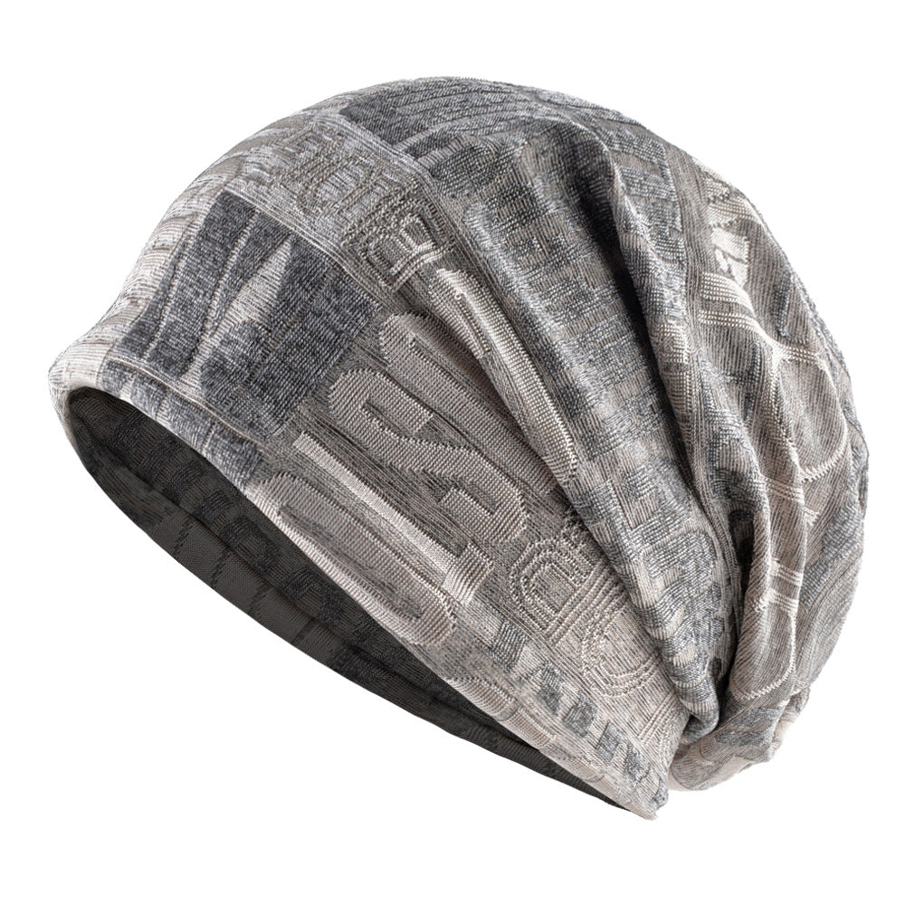 Lightweight black slouchy beanie hat with soft stretch fabric, embossed patterned surface / Black textured 
slouch beanie with a relaxed drape and subtle patterned detailing. 