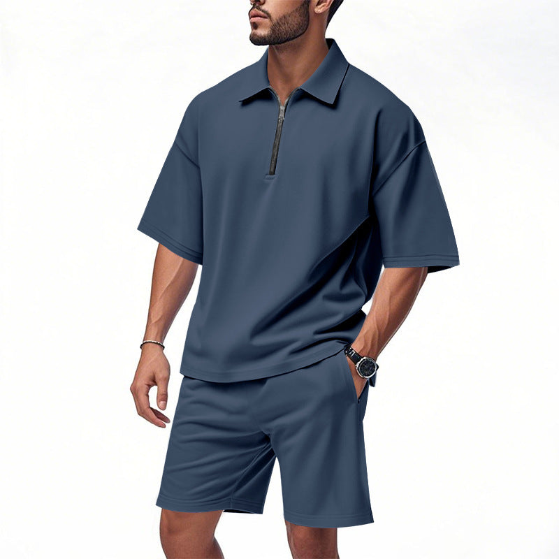 Man wearing a blue short sleeve zip neck polo shirt with matching shorts set.