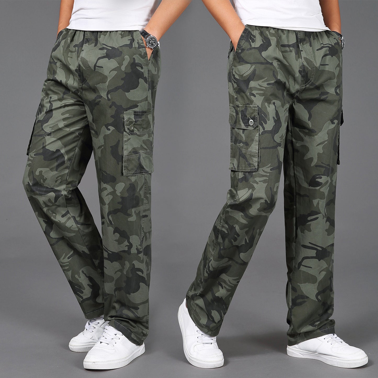 Man wearing army green camouflage cargo pants with multiple flap pockets and white sneakers, styled for 
military-inspired streetwear. 