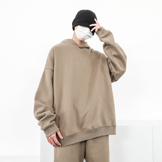 Plain gray oversized hoodie with dropped shoulders on a white background.