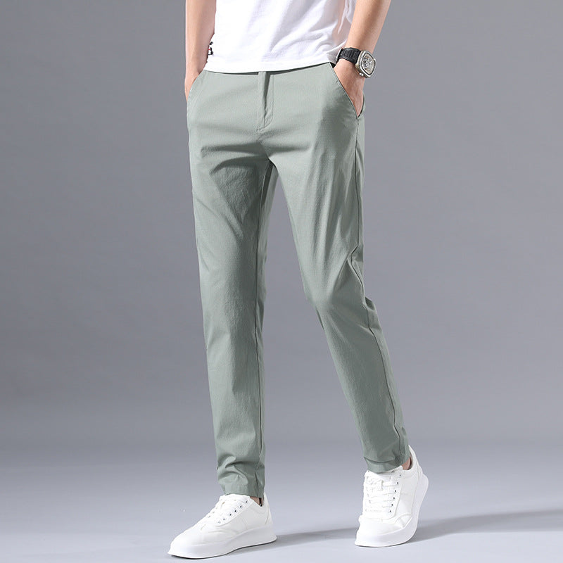 Man wearing black slim-fit formal trousers with button closure and belt loops, styled with a white shirt for 
business casual wear. 