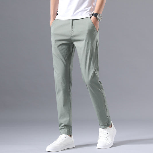 Man wearing black slim-fit formal trousers with button closure and belt loops, styled with a white shirt for 
business casual wear. 