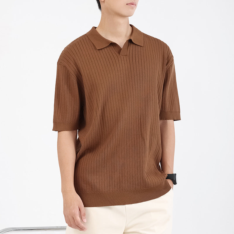 Men wearing a black ribbed knit short sleeve polo shirt with an open collar and slim fit design.