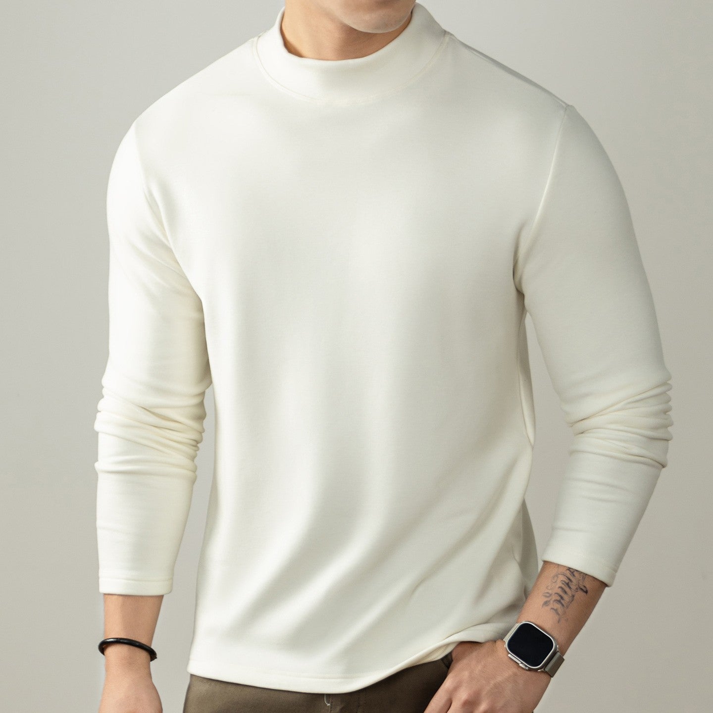 Man wearing a black long sleeve crew neck shirt. 