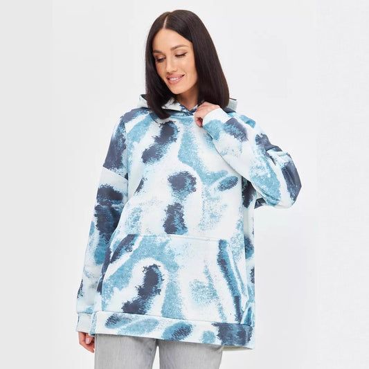 Woman wearing an oversized botanical / abstract color / leopard pattern print hoodie with a hood and front 
pouch pocket. 