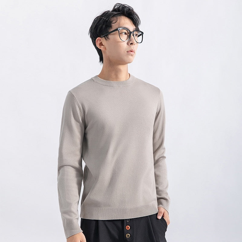 Men wearing a light beige slim fit crew neck knit sweater with ribbed cuffs, collar and hem.