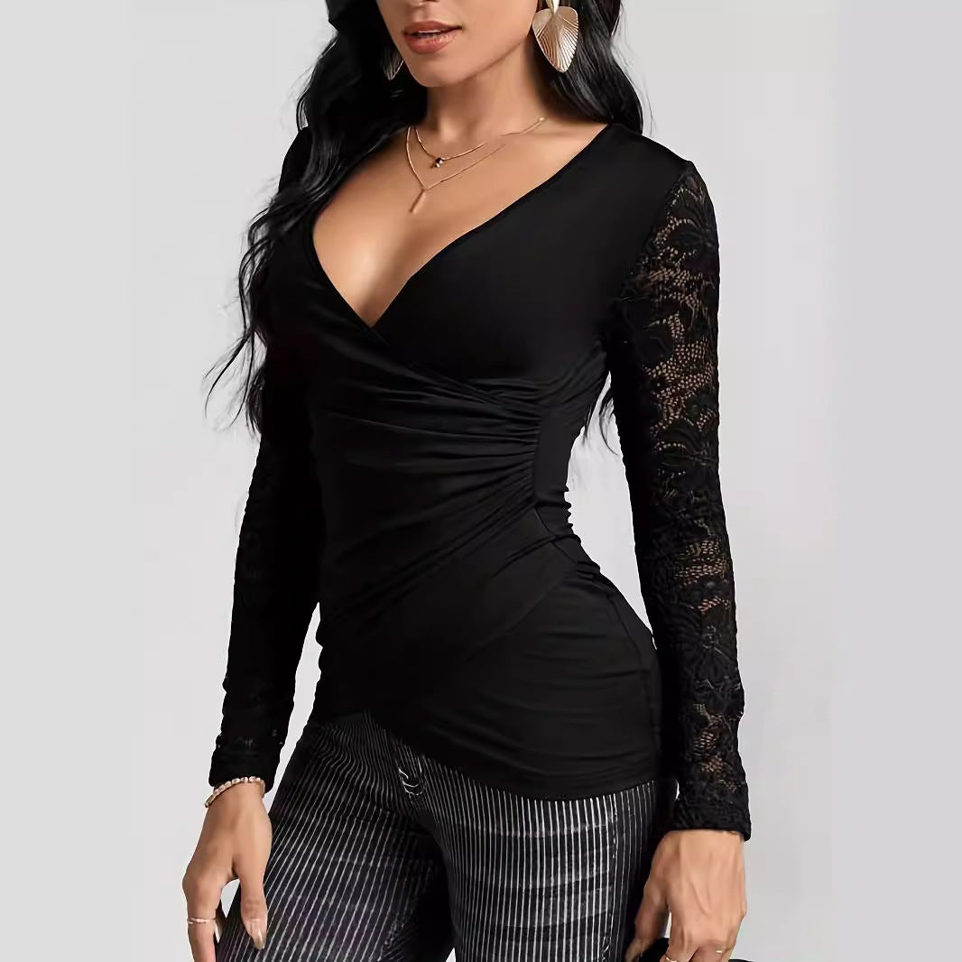 Woman wearing a black ruched wrap V-neck top with long lace sleeves and stripy pants. 