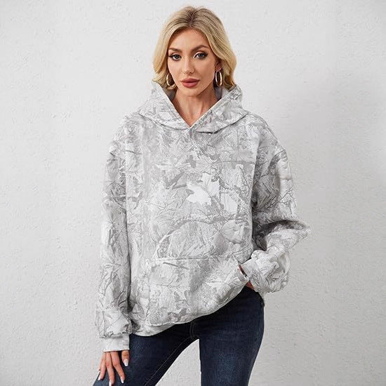 Woman wearing an oversized botanical / marble / leopard pattern print hoodie with drawstring hood and 
front pouch pocket. 