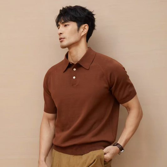 Man wearing a brown short-sleeve knit polo shirt styled with tan trousers. 